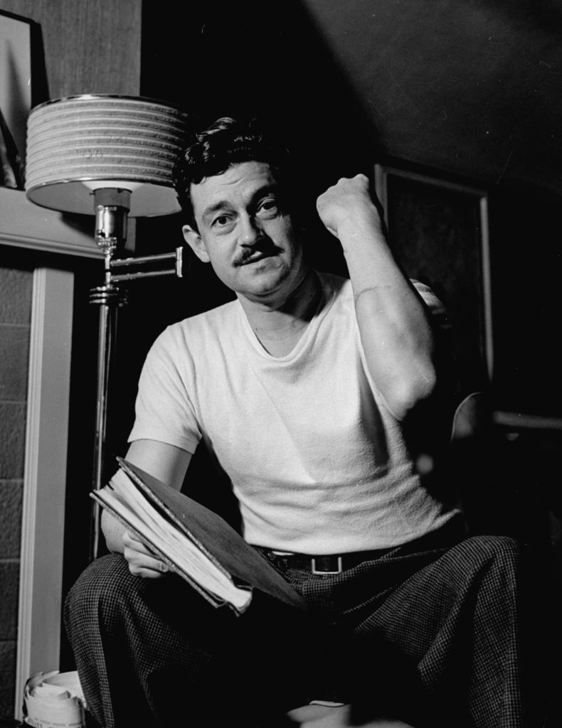 Writer and director Preston Sturges, in white tee shirt, showing cut on arm. (Photo by Paul Dorsey/The LIFE Picture Collection © Meredith Corporation)