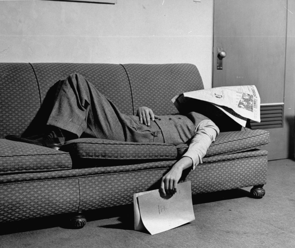 Writer Niven Busch lying on sofa with newspaper over his face as he takes nap from screenwriting. (Photo by Paul Dorsey/The LIFE Picture Collection © Meredith Corporation)
