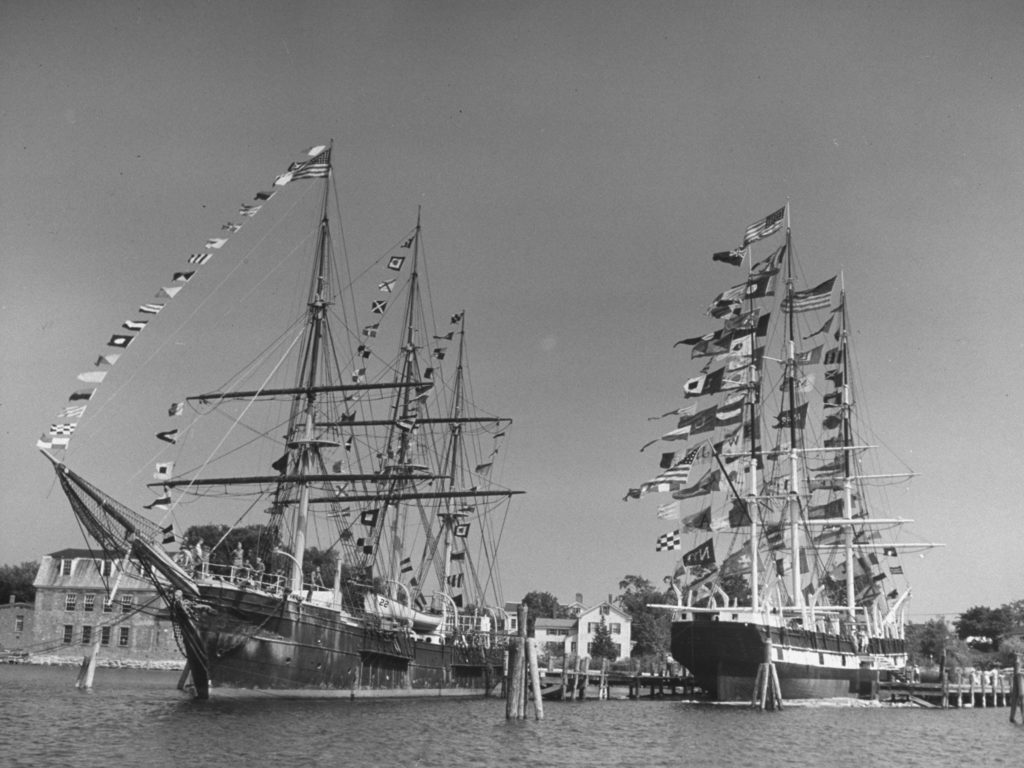 The sailing ship the Joseph Conrad (L) and the whaler Charles W. Morgan (R), both adorned with many flags. (Photo by Sam Shere/The LIFE Picture Collection © Meredith Corporation)