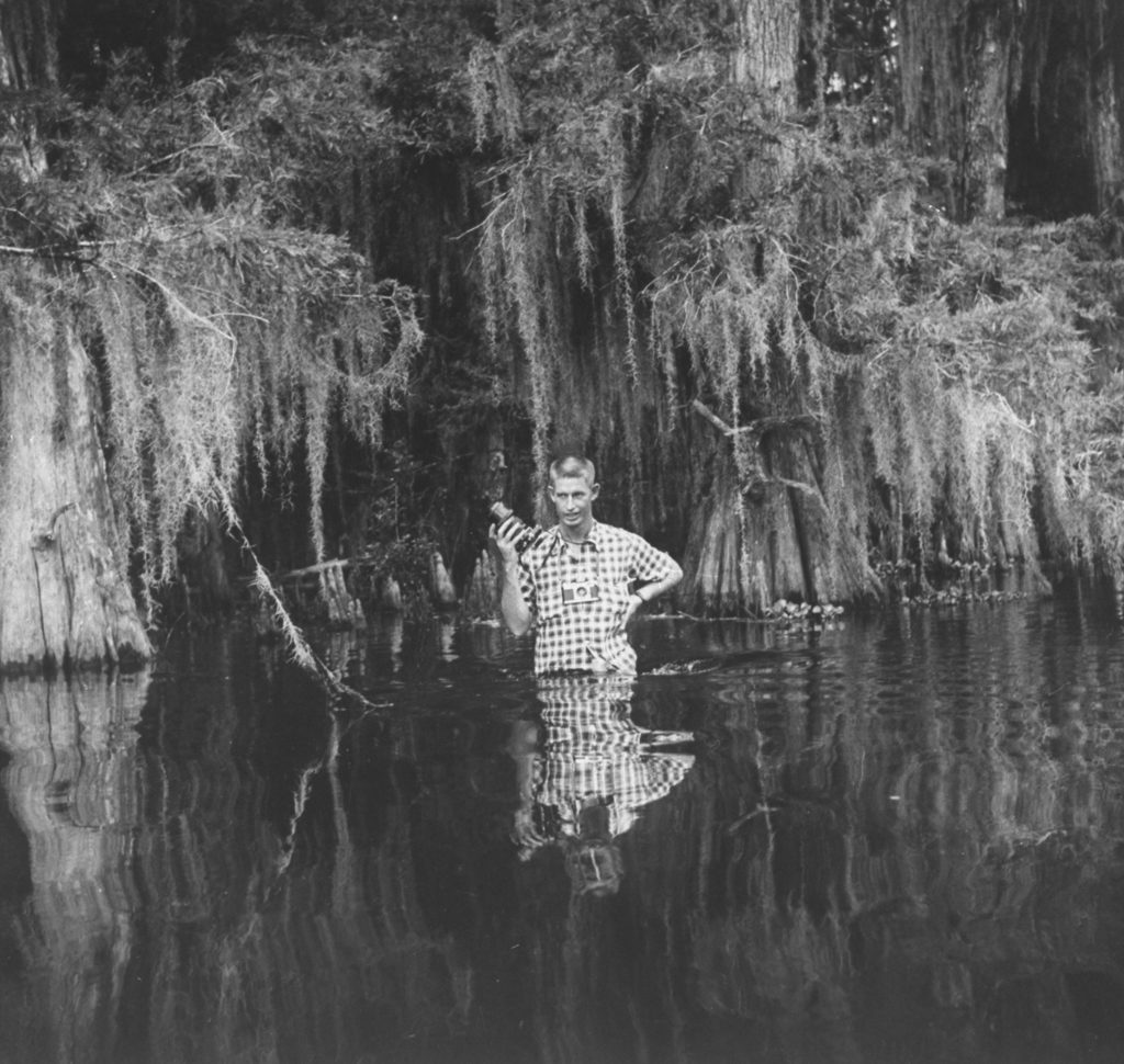 Stan Wayman standing in a swamp with his camera. (Photo by Stan Wayman/The LIFE Picture Collection © Meredith Corporation)