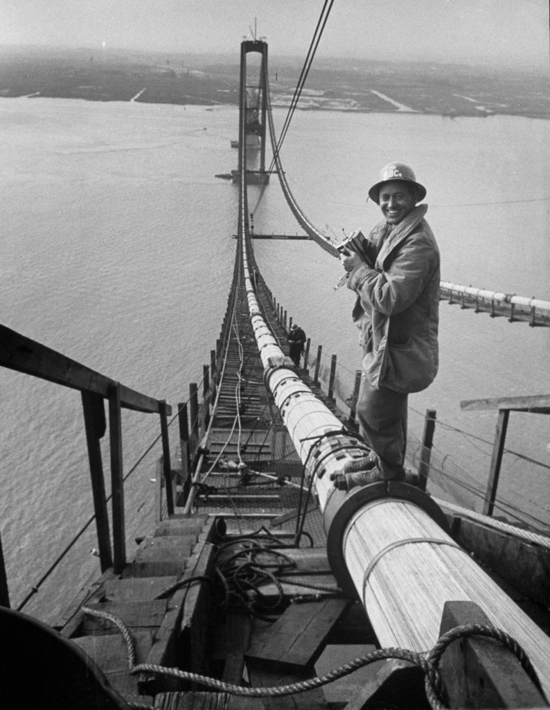 Peter Stackpole with his camera standing on a suspension cable as he covers the construction of the Delaware Memorial Bridge. (Photo by Peter Stackpole/The LIFE Picture Collection © Meredith Corporation)