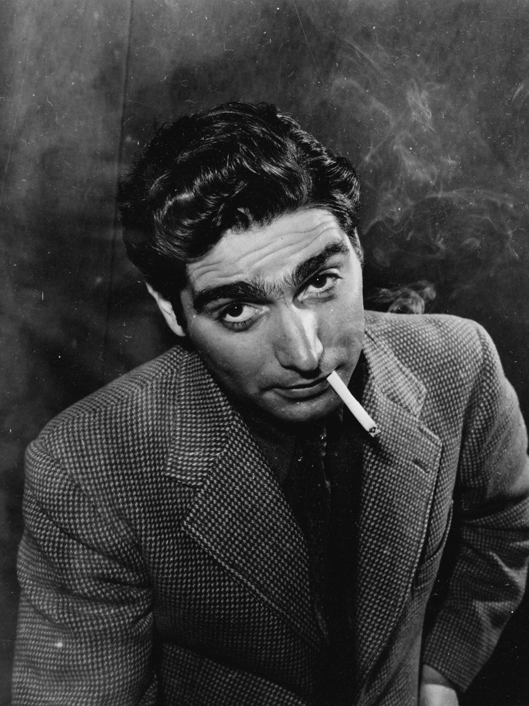 Portrait of Robert Capa smoking cigarettes. (Photo by Alfred Eisenstaedt/The LIFE Picture Collection © Meredith Corporation)
