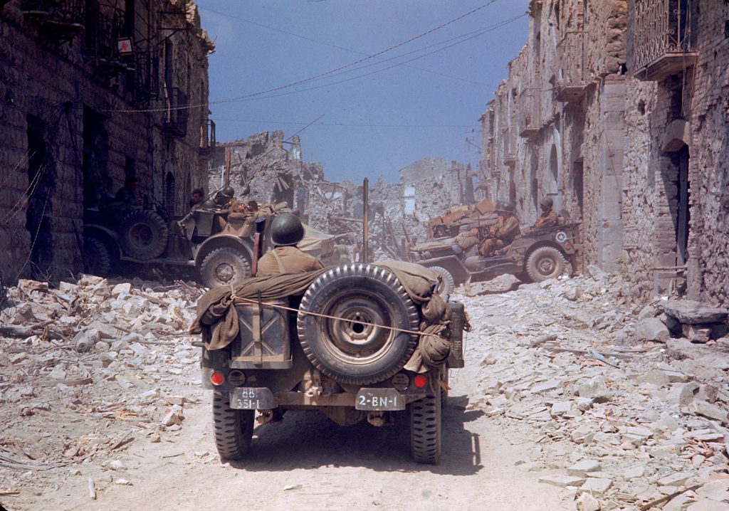 American jeeps travelled through a bombed-out town during the drive towards Rome, World War II.