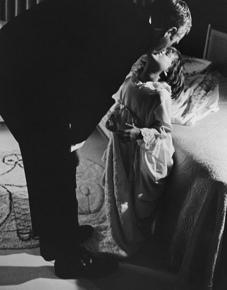 Steve McQueen kisses his daughter Terry goodnight in 1963.