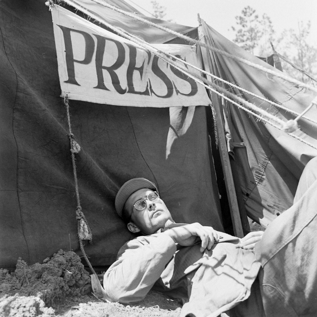 W. Eugene Smith in Okinawa, Japan, during World War II in front of the press tent. (Photo by W. Eugene Smith/The LIFE Picture Collection © Meredith Corporation)