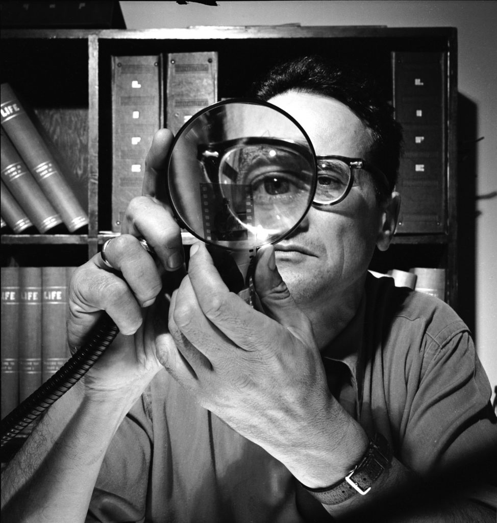 Andreas Feininger looking at negatives with a magnifying glass. (Photo by Andreas Feininger/The LIFE Picture Collection © Meredith Corporation)