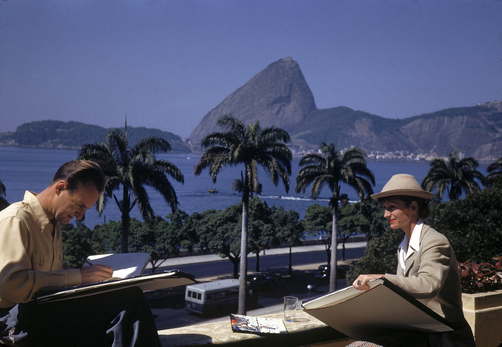 American movie producer, artist, and animator Walt Disney and fellow artist and animator Mary Blair sit on a balcony and draw on sketch pads while in South America. (Photo by Hart Preston/The LIFE Picture Collection © Meredith Corporation)
