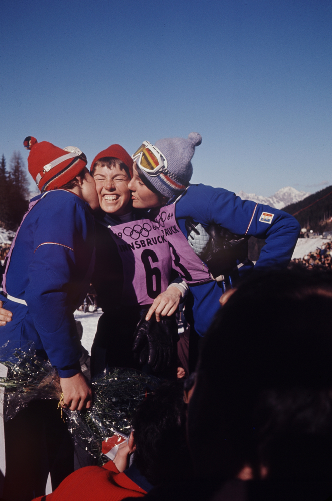 American skier Jean Saubert (center) gets kisses from French downhill gold and silver medalists (and sisters), Christine and Marielle Goitschel, Innsbruck Olympics, 1964.