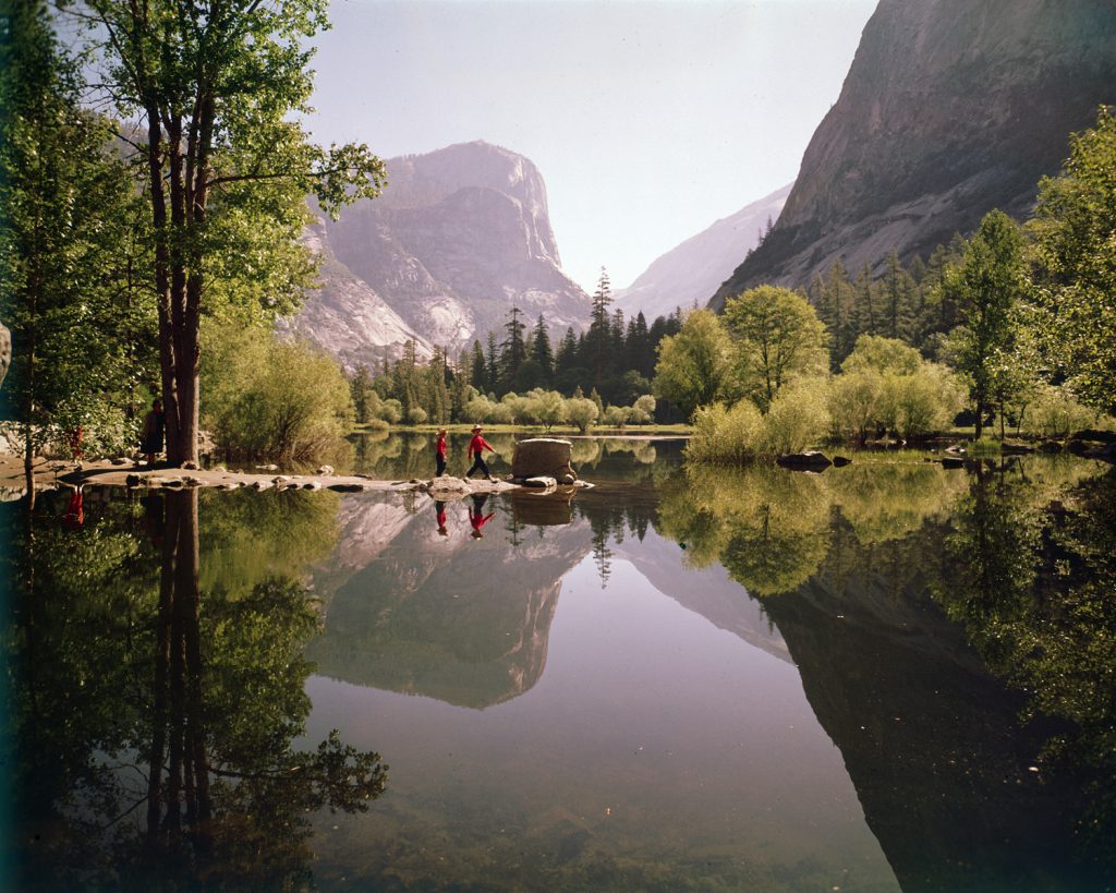 Children walk on a spit of rocks at Mirror Lake in Yosemite National Park, 1962.