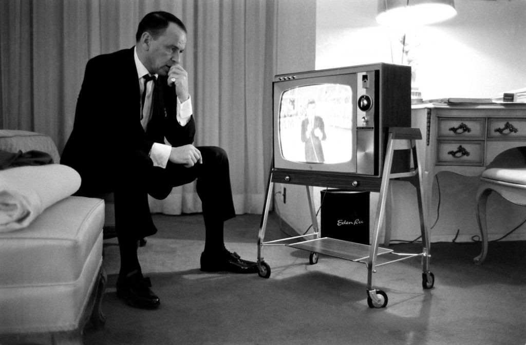 Frank Sinatra watches his son, Frank Jr., 21, emcee a TV show, 1964.