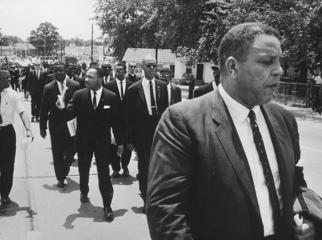 Martin Luther King, Jr., Ralph Abernathy and other civil rights leaders walk in Medgar Evers' funeral procession, Jackson, Miss..