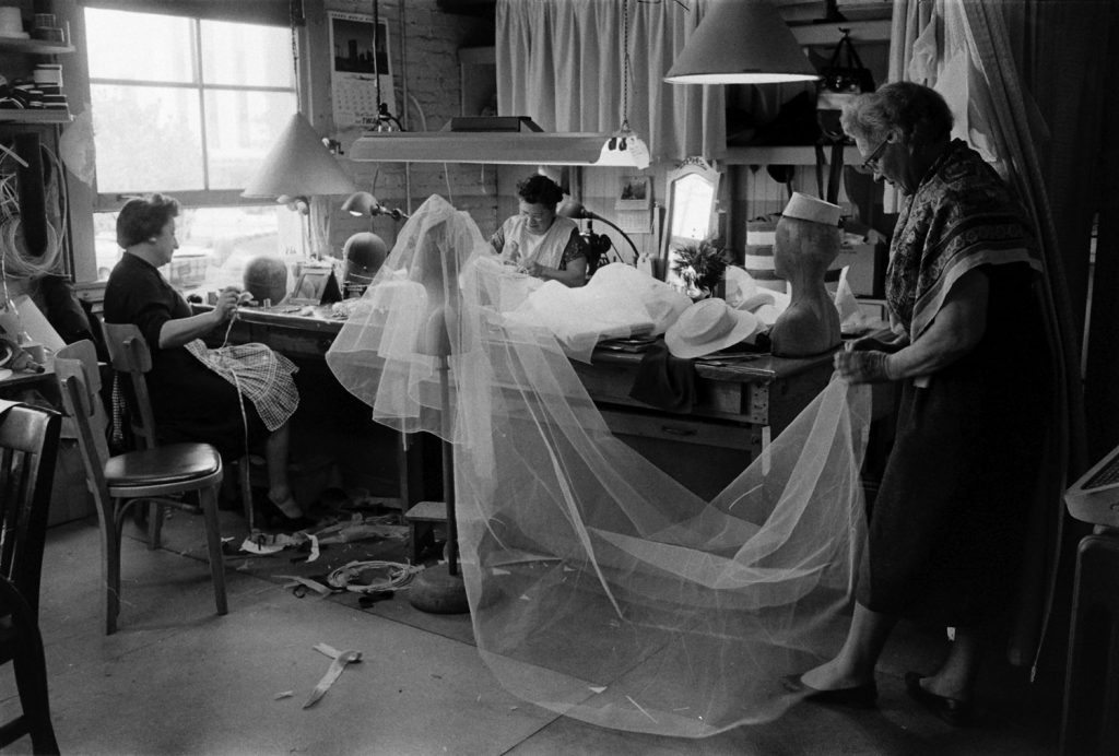 Seamstresses work on Grace Kelly's wedding dress and veil, conceived by MGM's wardrobe designer, Helen Rose, Hollywood, Calif., 1956.