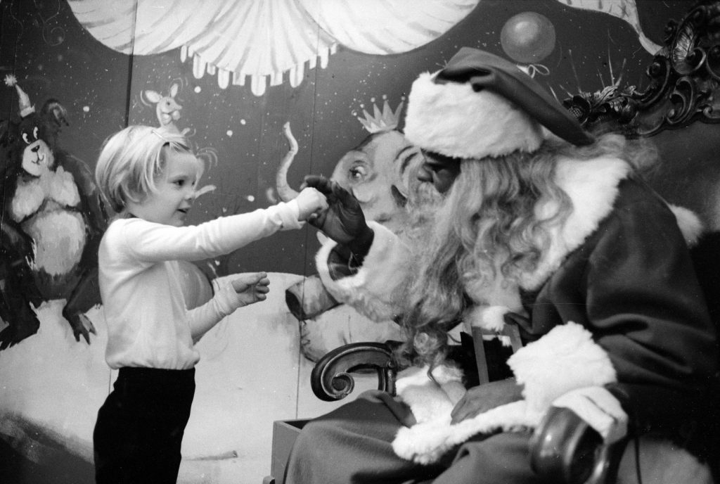 Young child visiting Santa Claus at a department store, 1970.