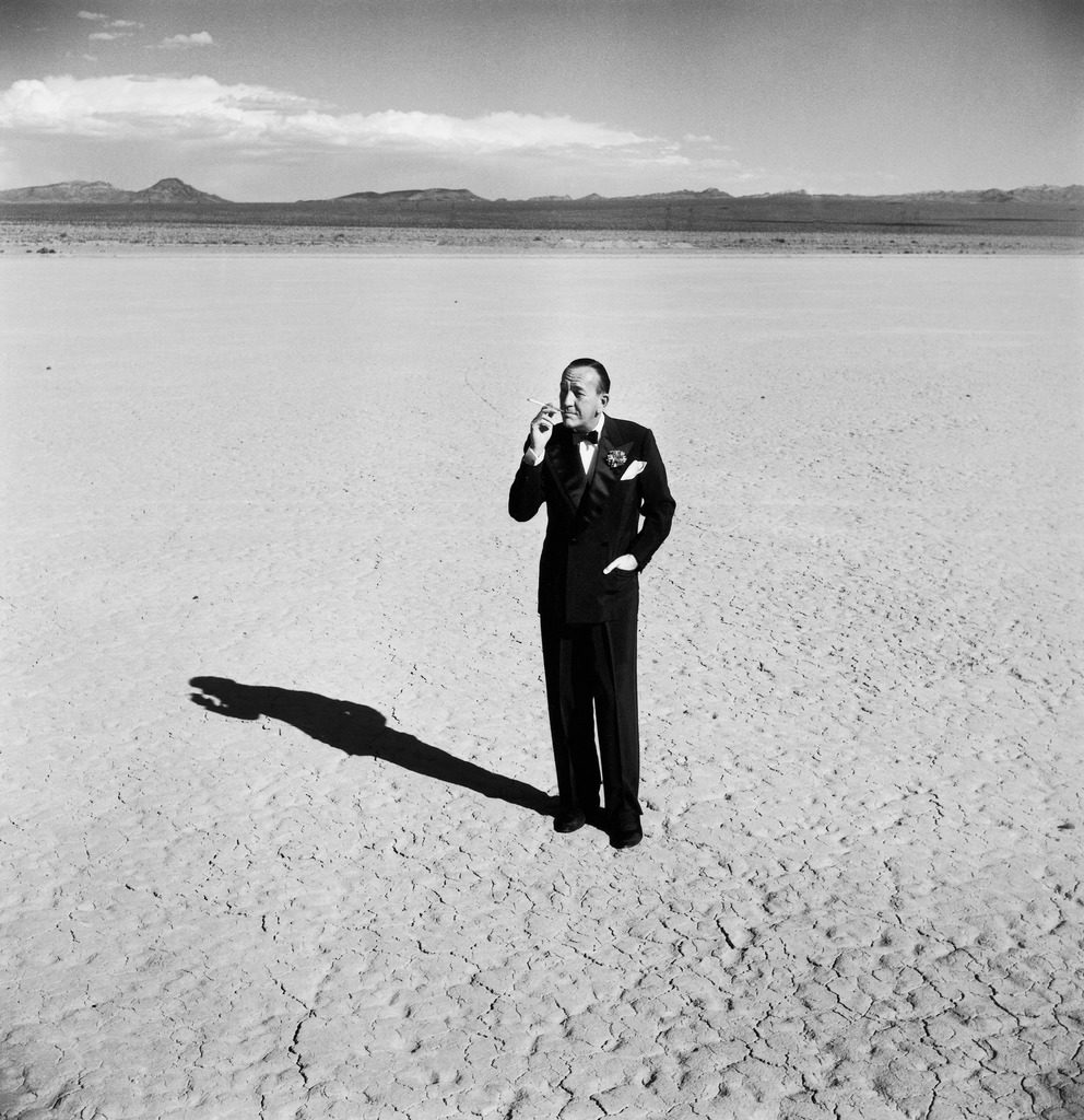 British entertainer Noel Coward in middle of desert, dressed for his nightclub act. (Photo by Loomis Dean/The LIFE Picture Collection © Meredith Corporation)