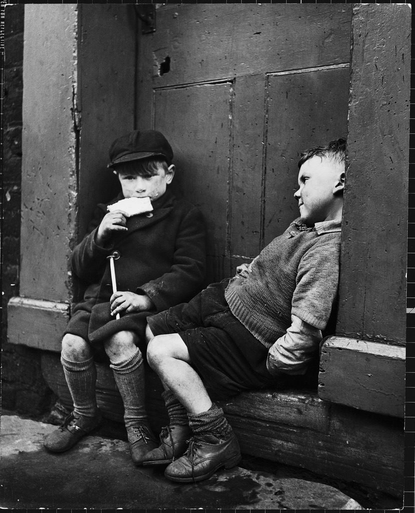 Two boys sitting on doorstep. (Photo by N.R. Farbman/The LIFE Picture Collection © Meredith Corporation)