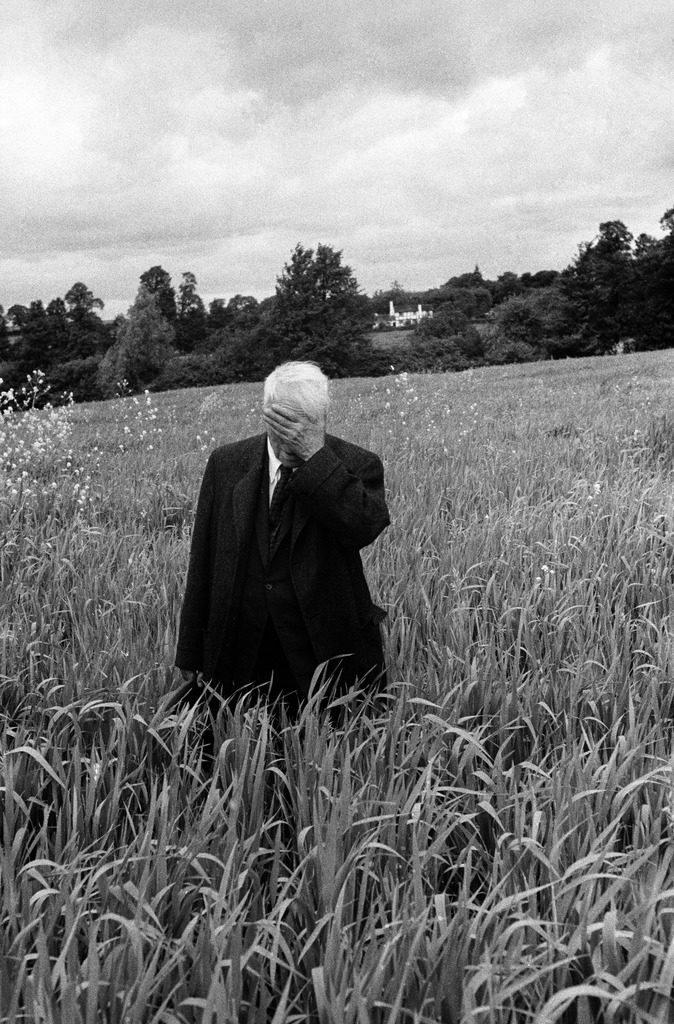 Poet Robert Frost standing in Oxford field with his hand over his face. (Photo by Howard Sochurek/The LIFE Picture Collection © Meredith Corporation)