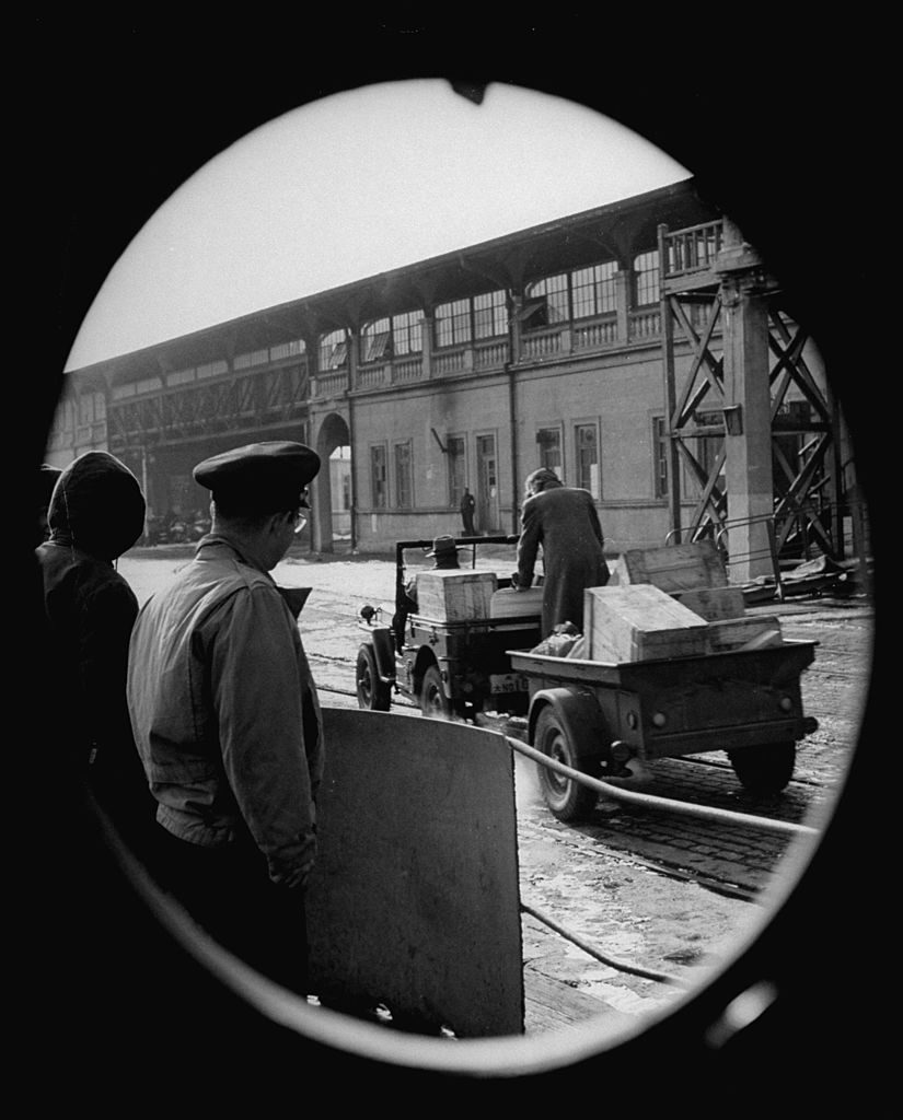 Consul general supervising the movement of provisions between locomotives and ships docked at the port of Dairen in Manchuria, China, December 1946. Dairen is the headquarters of the South Manchuria Railroad, as well as a very busy harbor. (Photo by Mark Kauffman/The LIFE Picture Collection © Meredith Corporation)