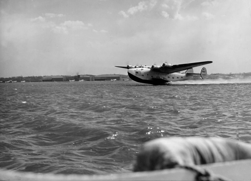 Pan American Clipper passenger plane skimming the surface of water during take-off of 23-hour transatlantic flight to Lisbon, Portugal. (Photo by Bernard Hoffman/The LIFE Picture Collection via © Meredith Corporation)