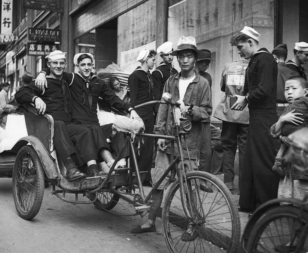 American sailors on shore leave sit in a pedicab while their buddy takes their picture, Shanghai, China, December 1945. (Photo by George Lacks/The LIFE Picture Collection © Meredith Corporation)