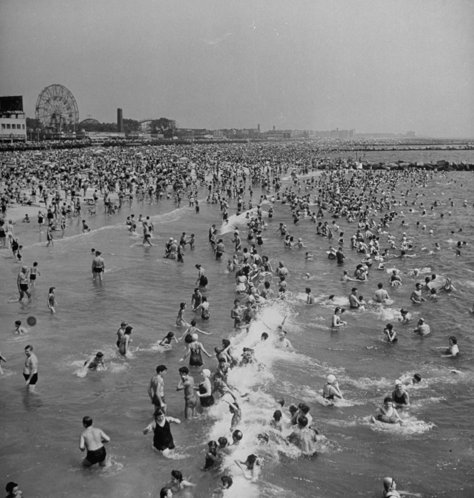 Huge crowd gathered in the surf and amp; at the beach in front of Coney Island Amusement Park. (Photo by Marie Hansen/The LIFE Picture Collection © Meredith Corporation)