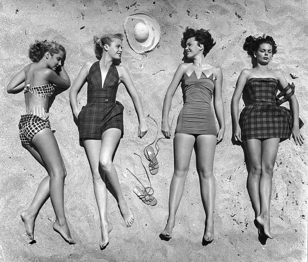 Models lying on beach to display bathing suits. (Photo by Nina Leen/The LIFE Picture Collection © Meredith Corporation)