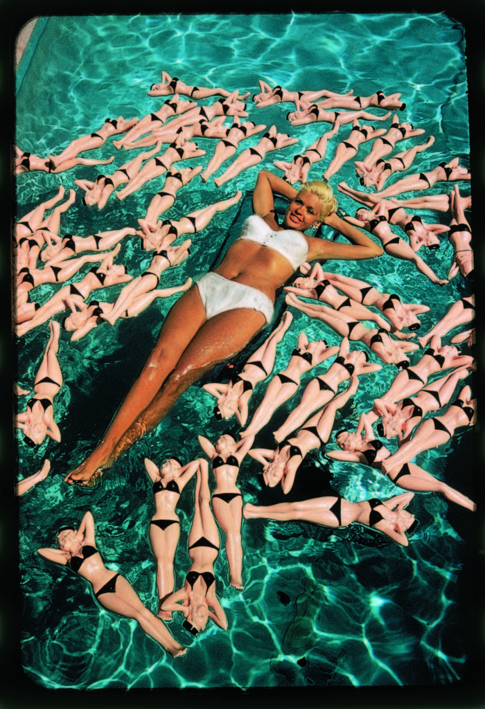 Bikini clad actress Jayne Mansfield posing with shapely bottles floating around her in her pool. (Photo by Allan Grant/The LIFE Picture Collection © Meredith Corporation).