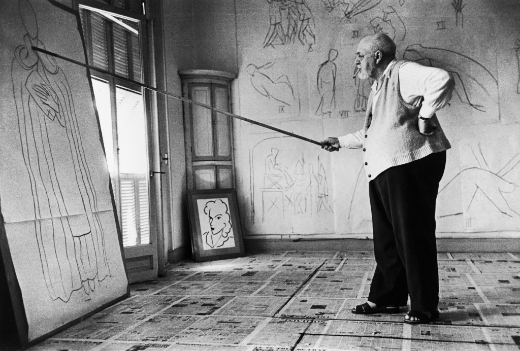 Painter Henri Matisse using a bamboo pole tipped with charcoal to draw a half-scale figure of St. Dominic. (Photo by Robert Capa/The LIFE Images Collection)