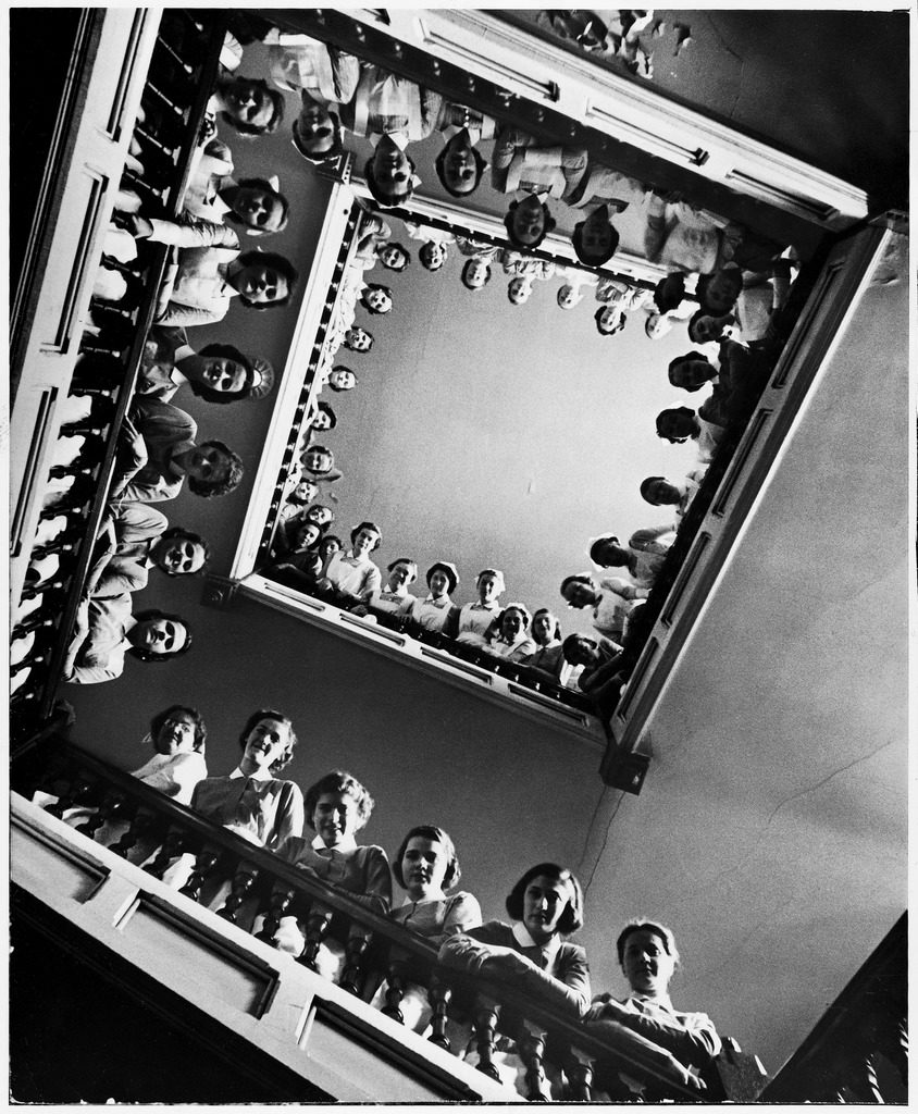 Student nurses lining the railings of a stairwell at Roosevelt hospital. (Photo by Alfred Eisenstaedt/The LIFE Picture Collection © Meredith Corporation)