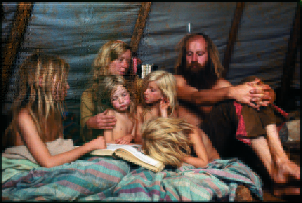 Tent-dwelling hippie family reading bedtime stories. (Photo by John Olson/The LIFE Picture Collection © Meredith Corporation)