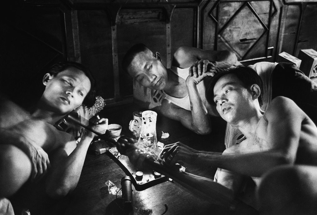 Opium addicts smoking, sleeping, and talking together in a "desintoxication clinic." (Photo by Jack Birns/The LIFE Picture Collection © Meredith Corporation)