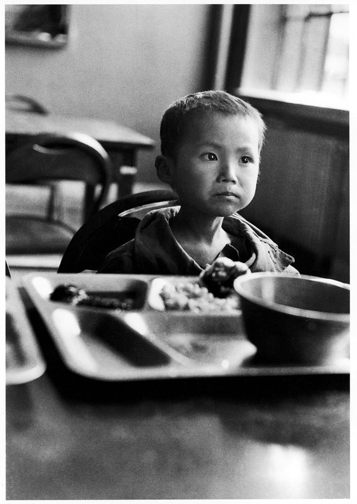 Korean orphan Kang Koo Ri sitting at table eating meal in orphanage after a US soldiers found him next to his dead mother. (Photo by Michael Rougier/The LIFE Picture Collection © Meredith Corporation)