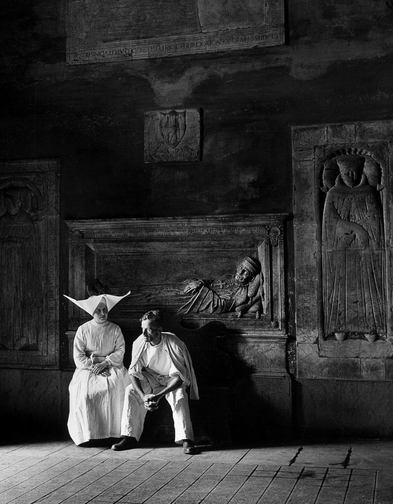 Two people sitting in hospital where St. Catherine nursed people with the plague. (Photo by Walter Sanders/The LIFE Picture Collection © Meredith Corporation)