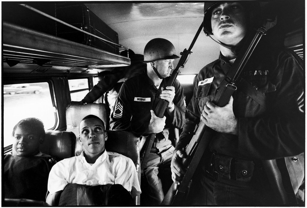 Freedom Riders Julia Aaron & David Dennis sitting on board interstate bus as they are escorted by two Mississippi National Guardsmen holding bayonets, on way from Montgomery, Alabama to Jackson, Mississippi. (Photo by Paul Schutzer/The LIFE Picture Collection © Meredith Corporation)