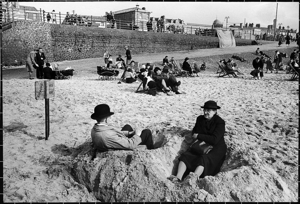 People sitting in the sand at Blackpool beach. (Photo by Ian Smith/The LIFE Picture Collection © Meredith Corporation)