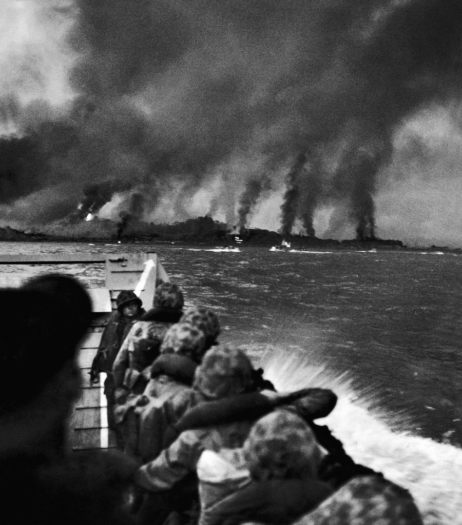 US Marines crouched in landing boat, looking at the bombardment of the beach where they are about to land. (Photo by Hank Walker/The LIFE Picture Collection © Meredith Corporation)