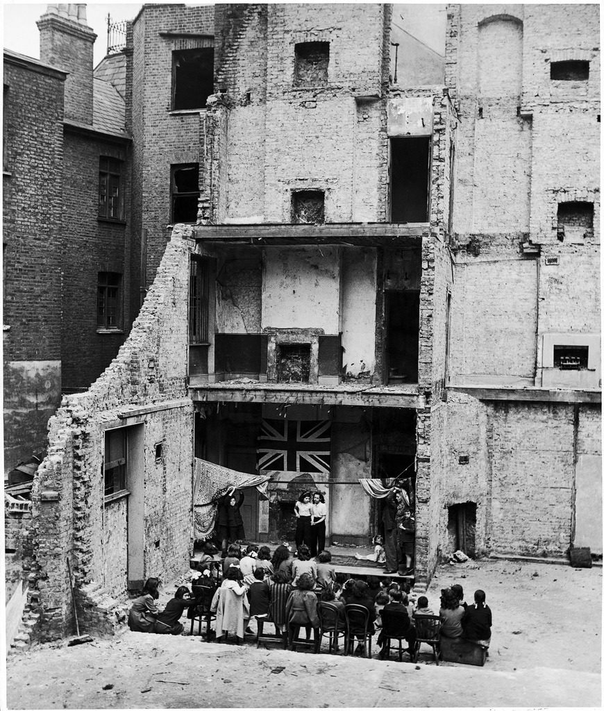 Children in Aldgate using the ruins of a bombed house as a stage for a vaudeville show. (Photo by Hans Wild/The LIFE Picture Collection © Meredith Corporation)